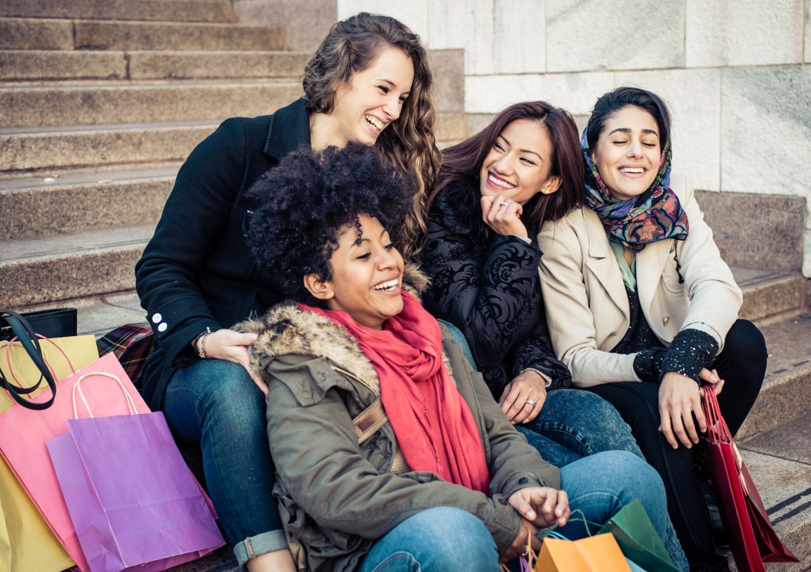 Photo of groups of friends laughing and taking a break after busy shopping day