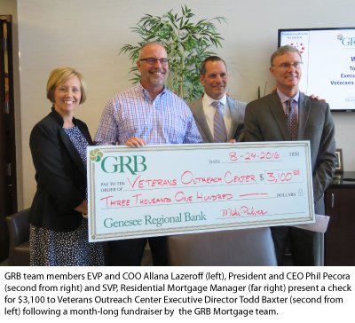 GRB's Executive team presents $3,100 to the VOC's Todd Baxter