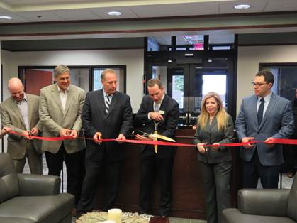 Photo of guests cutting the ribbon in Greece Branch