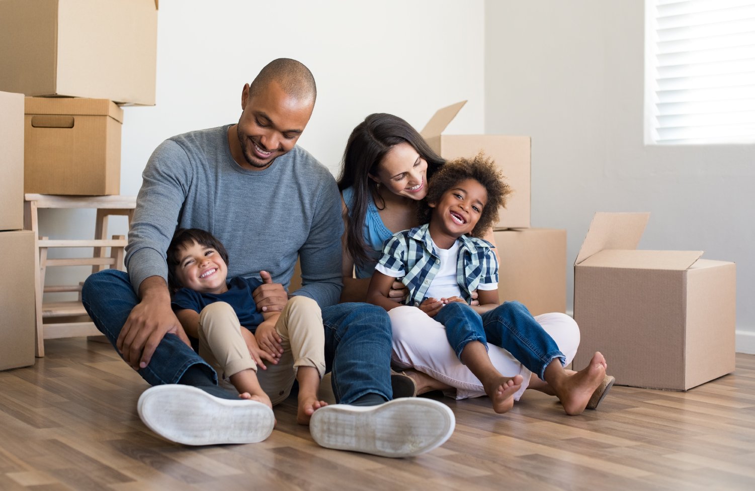 A young family unpacks after receiving home mortgage financing for their new home.