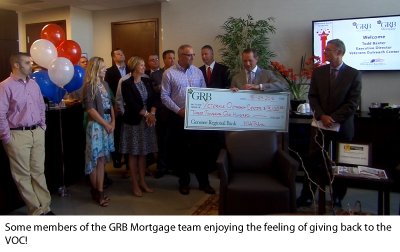 Photo of GRB employees participating in the ceremony presenting the check to the Veterans Outreach Center.