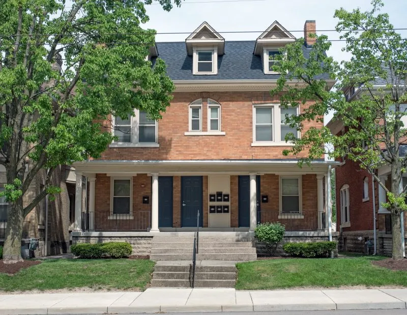 Front view of a brick house that has been converted to a multi-family residence
