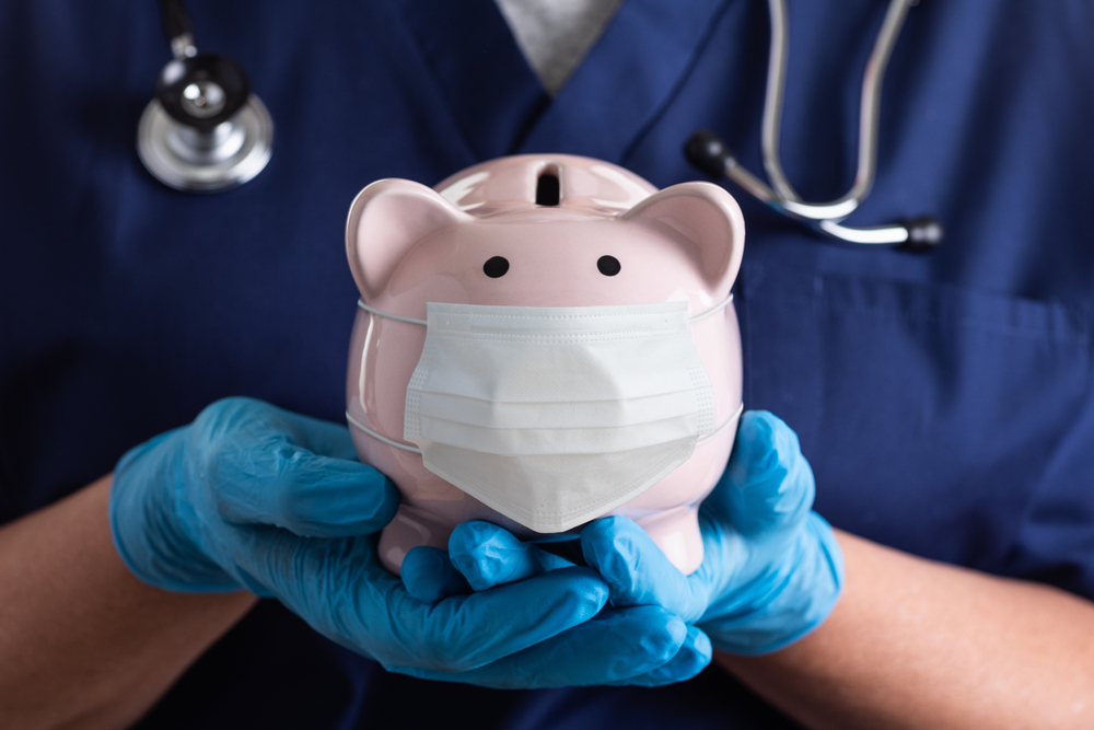 Piggy bank with healthcare mask representing financing for medical and dental equipment.