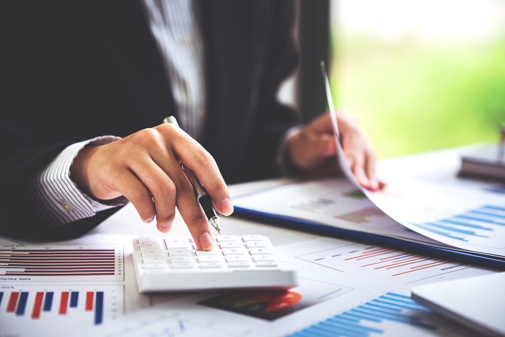 Man in suit looking at debt for refinancing