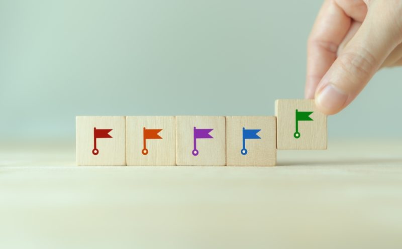 Wooden blocks with flag pings demonstrating timeline