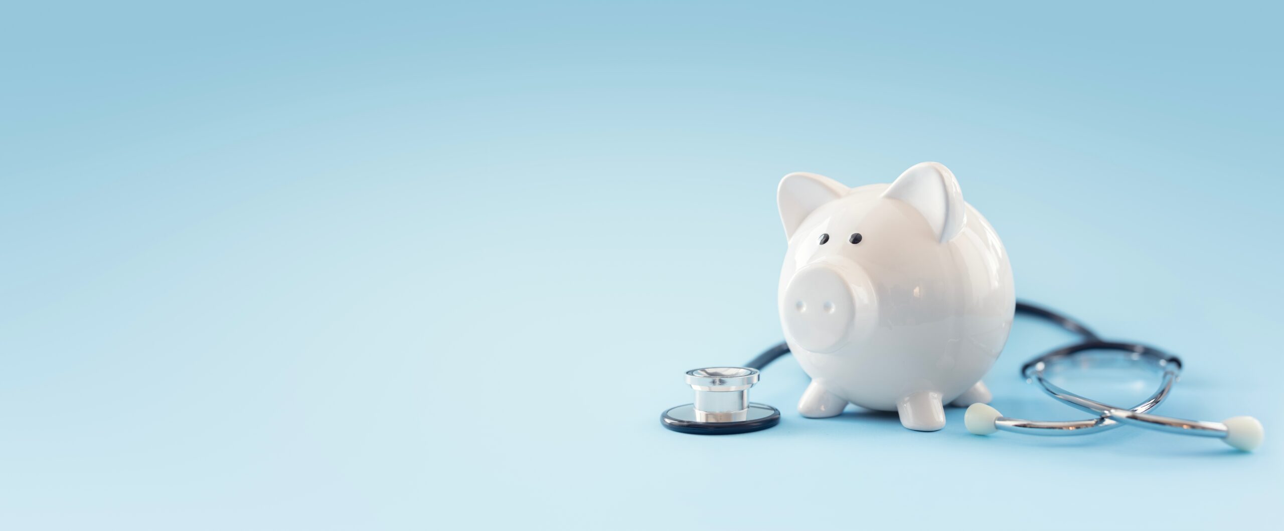 Piggy Bank with a stethoscope wrapped around it.