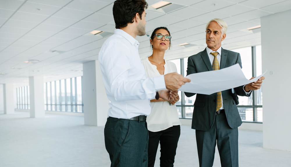 Medical professionals meeting with a real estate agent to discuss leasing space for a new office